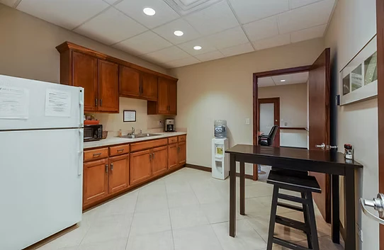 Shared tenant kitchen with refrigerator, sink, coffee and water at Washington Place, Oswego IL