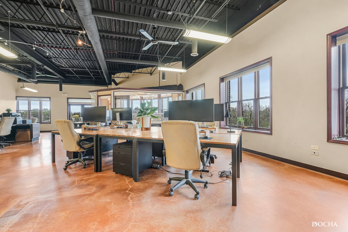 Suite 322 open workspace with exposed beam ceiling and park views - Washington Place, Oswego, IL