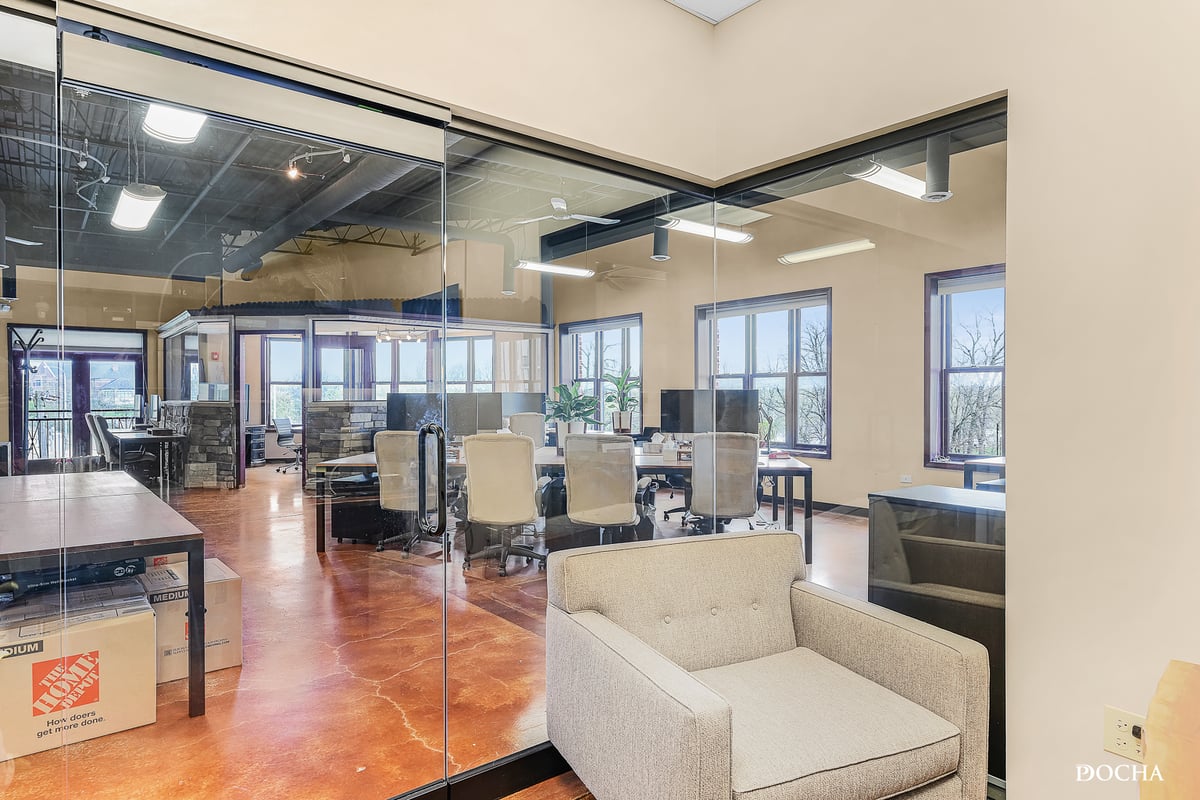 Suite 322 view through glass office wall to open workspace and park views, Washington Place, Oswego, IL