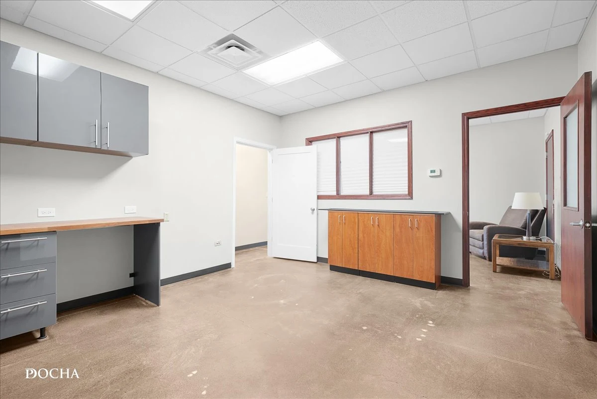 Suite 327 built-in desk and cabinetry with stained concrete floors - 400 SF office space at Washington Place, Oswego, IL