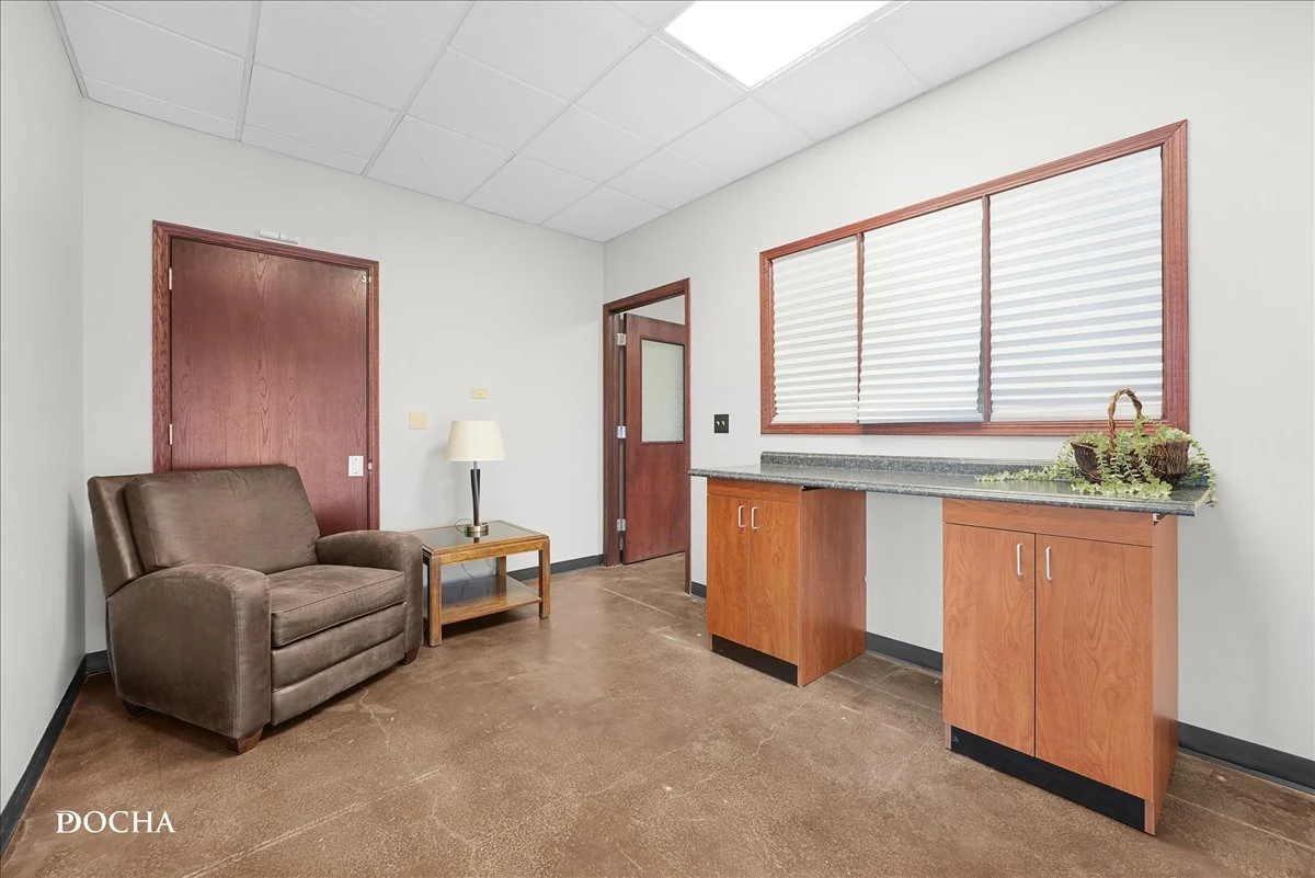 Suite 327 private office with seating area, window, and granite-topped built-in cabinetry - Washington Place, Oswego