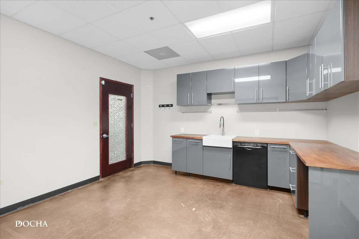 Suite 327 built-out kitchen with farmhouse sink, dishwasher, and butcher block counters - Oswego, IL office space